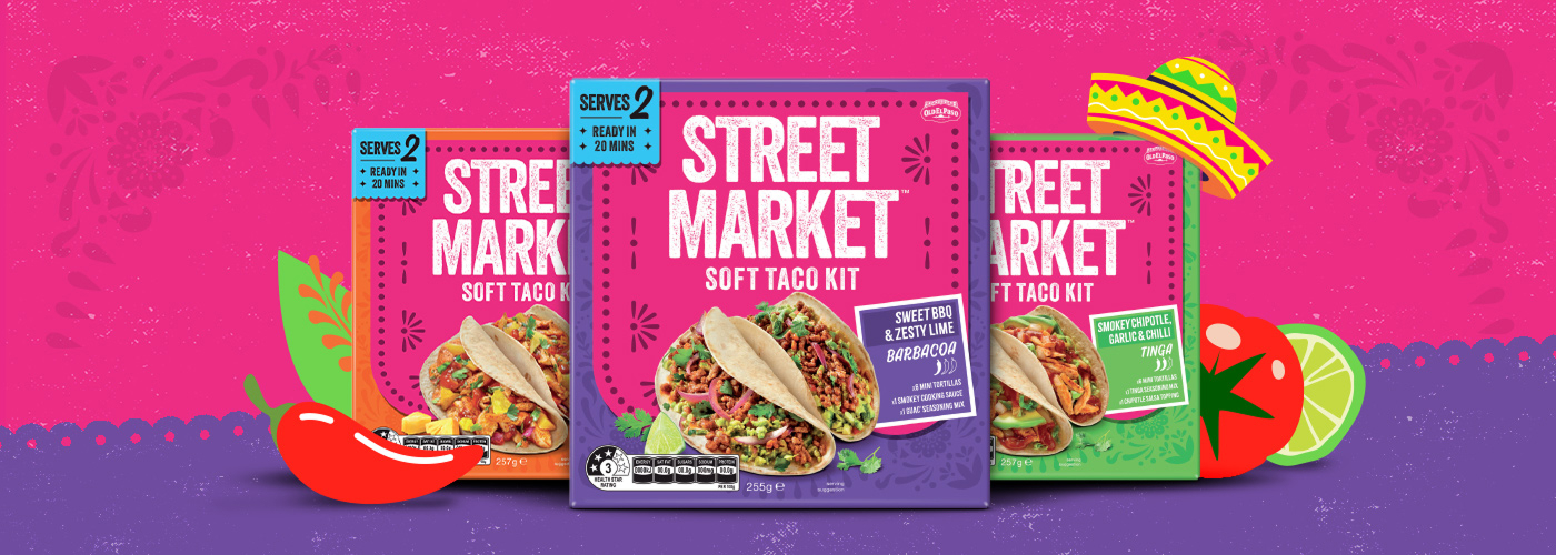 Three Street Market soft taco kits in colorful packaging, with illustrated taco-themed graphics in the background.